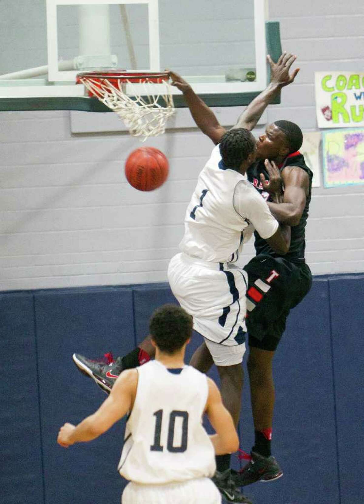 Terry's Derrick Griffin, right, dunks over Lamar's Wannah Bail during a 23-4A district game between Lamar Consolidated and Terry, Tuesday, January 3, 2012 in Rosenberg, Texas.