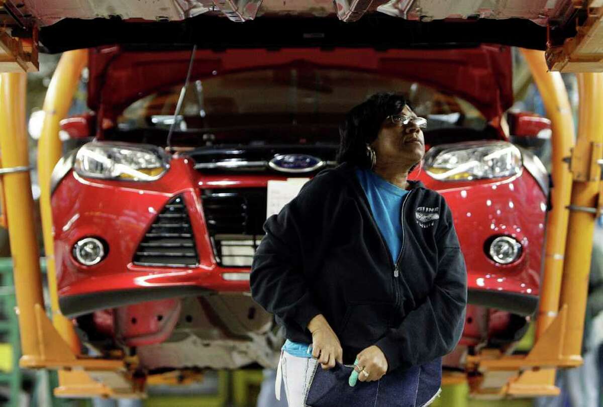 In this Dec. 14, 2011 photo, Bonita Bride assemble a 2012 Ford Focus at the Ford Michigan Assembly plant in Wayne, Mich. The Commerce Department said Wednesday, Jan. 4, 2012, orders to U.S. factories rose 1.8 percent in November, following two months of declines. It was the best showing since a 2.1 percent gain in July. (AP Photo/Paul Sancya)