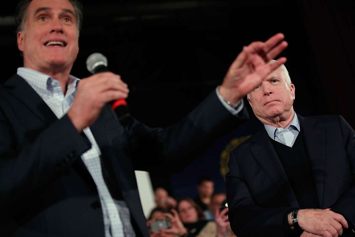 PETERBOROUGH, NH - JANUARY 04: Republican presidential candidate and former Massachusetts Governor Mitt Romney (L) and former presidential nominee U.S. Sen. John McCain (R-AZ) hold a campaign town hall meeting at the Peterborough Town House January 4, 2012 in Peterborough, New Hampshire. McCain announced his endorsement of Romney the day after Romney beat former U.S. Senator Rick Santorum by only eight votes in Tuesday's "first in the nation" Iowa Caucuses. (Photo by Chip Somodevilla/Getty Images)