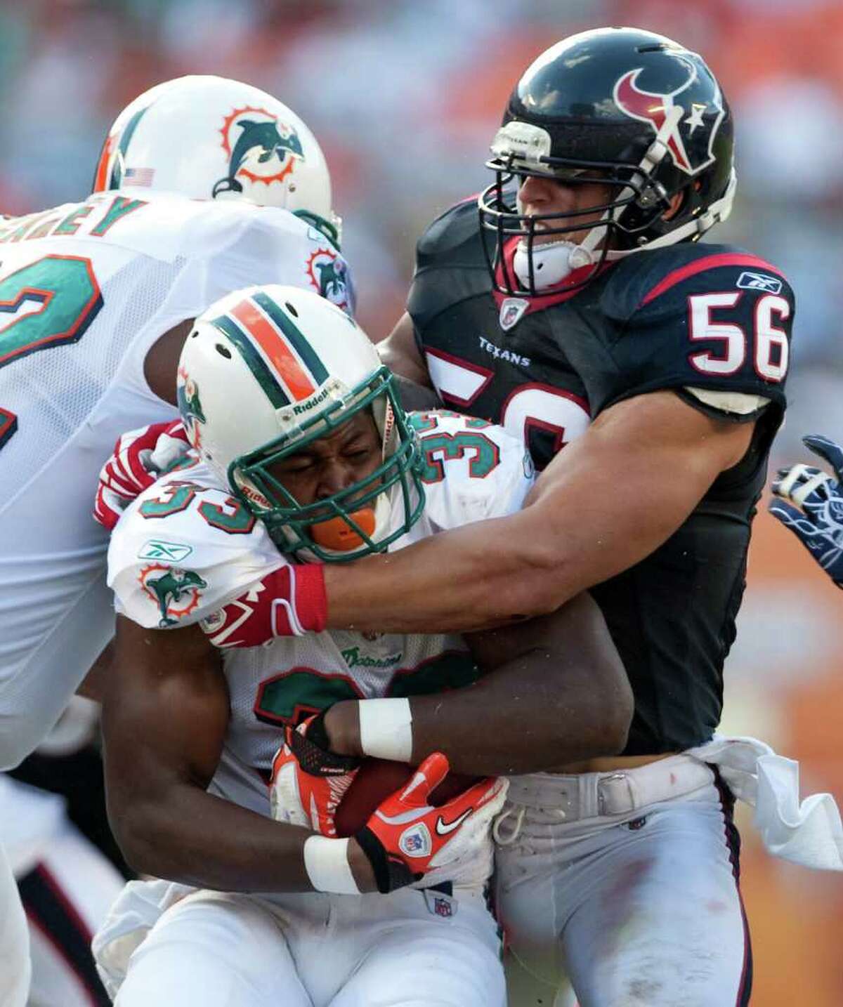 Dolphins running back Daniel Thomas meets a brick wall in the form of Texans linebacker Brian Cushing during Game 2 at Sun Life Stadium in Miami.