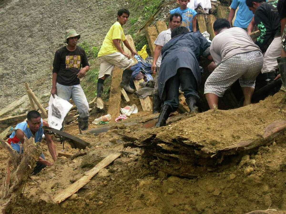 In this photo released by the Philippine Army, residents dig through the rubble following a landslide that occurred at the small-scale mining community of Pantukan, Compostela Valley in southern Philippines Thursday Jan. 5, 2012. The landslide tore through a small-scale gold mining site in the southern Philippines on Thursday, months after government officials warned miners that the mountain above them was guaranteed to crumble. (AP Photo/Philippine Army, Senior Police Officer 4 Zoilo Molles Jr.) NO SALES, EDITORIAL USE ONLY
