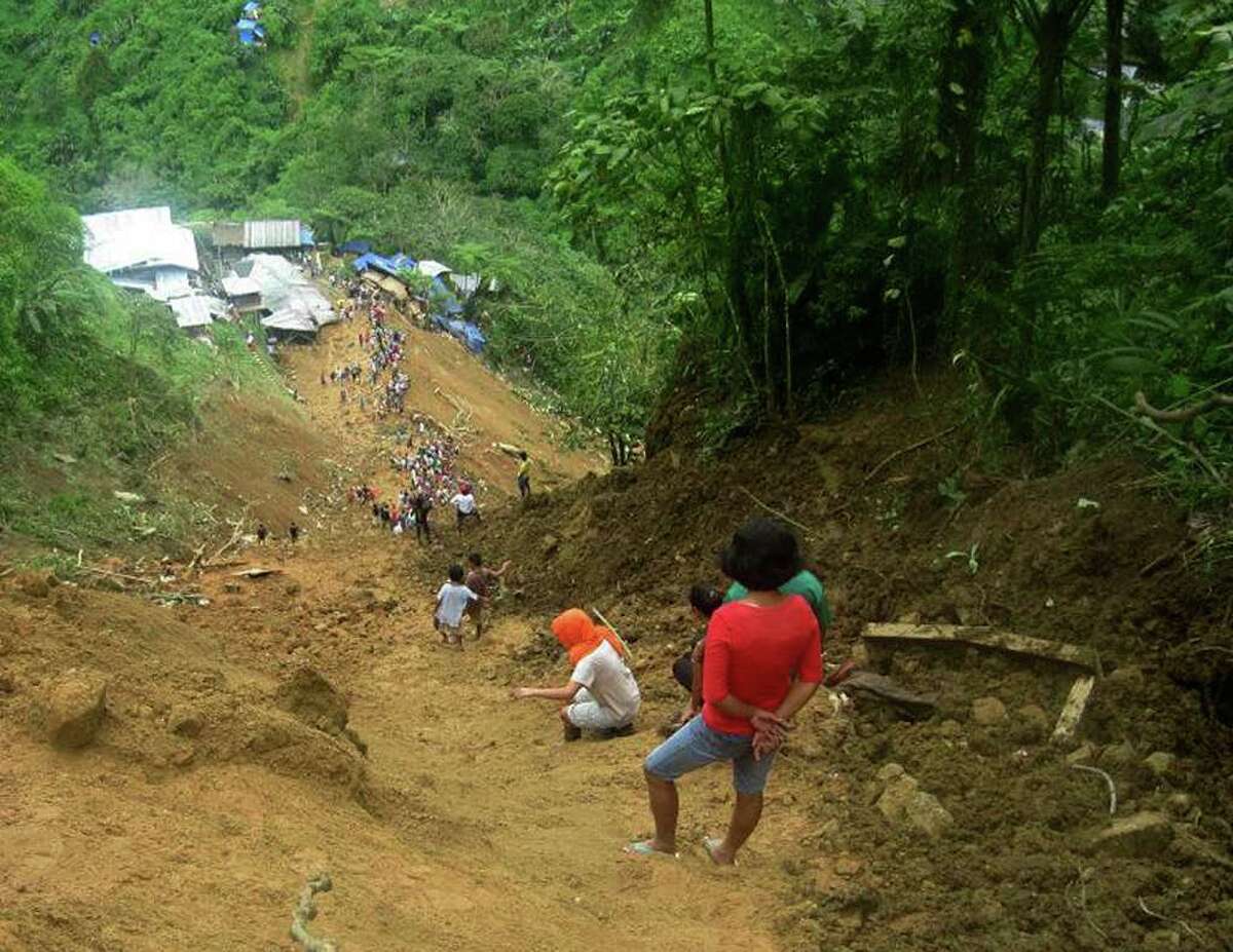 In this photo released by the Philippine Army, residents dig through the rubble following a landslide that occurred at the small-scale mining community of Pantukan, Compostela Valley in southern Philippines Thursday Jan. 5, 2012. The landslide tore through a small-scale gold mining site in the southern Philippines on Thursday, months after government officials warned miners that the mountain above them was guaranteed to crumble. (AP Photo/Philippine Army, Senior Police Officer 1 Roger Montejo) NO SALES, EDITORIAL USE ONLY