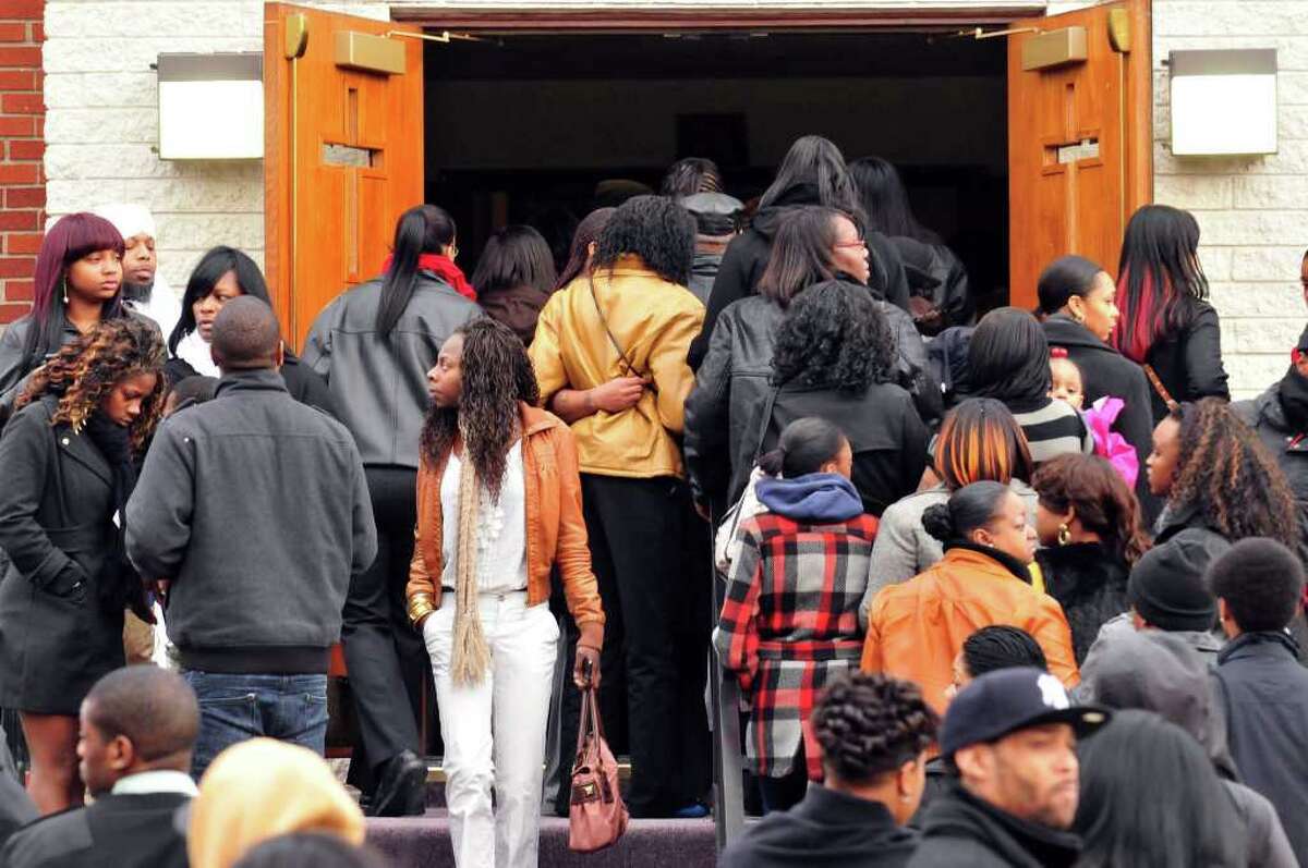 Mourners leave the Metropolitan New Testament Mission Baptist Church in Albany following the funeral services for Nah-Cream Moore on Thursday, Jan.5, 2012. ( Michael P. Farrell/Times Union)