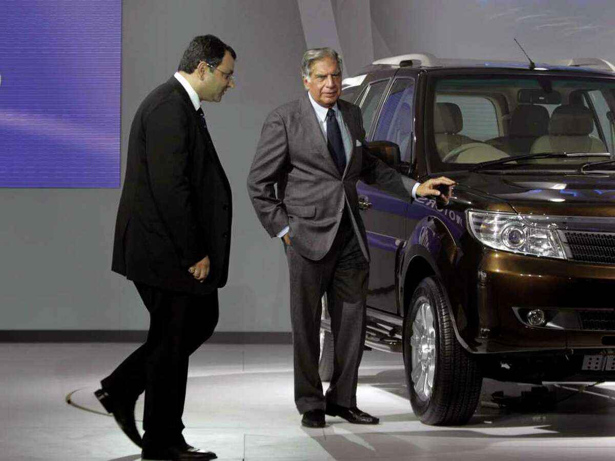 Tata Sons Chairman Ratan Tata, center, and deputy chairman Cyrus Mistry, left, pose near a Tata Safari during a press preview at the India Auto Expo, in New Delhi, India, Thursday, Jan. 5, 2012. The five day long automobile event begins Saturday. (AP Photo/ Manish Swarup)