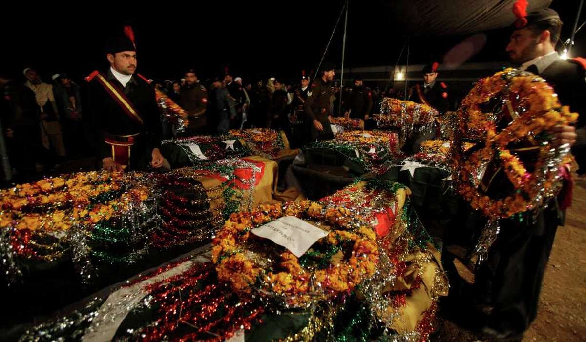 Pakistani security personnel attend a funeral of their colleagues in Peshawar, Pakistan on Thursday, Jan 5, 2012. Pakistani militants on Thursday killed 15 security force members they kidnapped last month close to the Afghan border, showing that not all insurgent factions are interested in reported peace talks with the government.