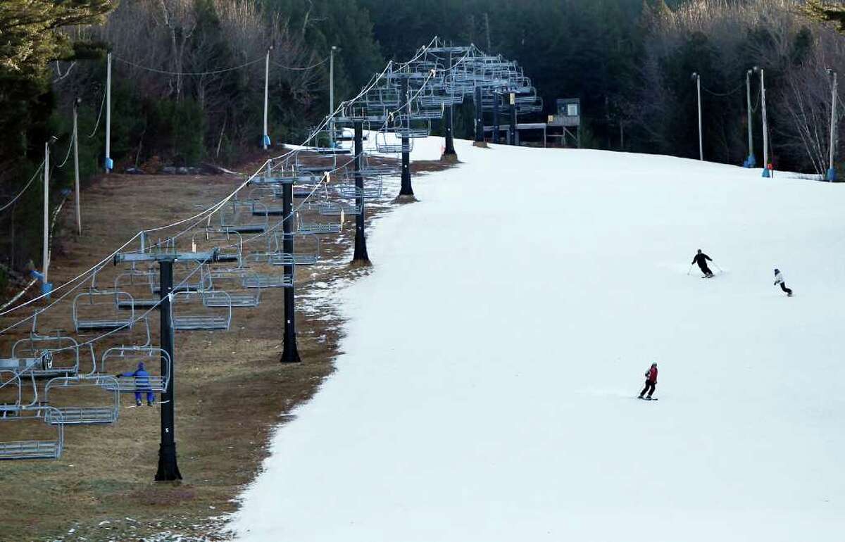 Man-made snow coats a ski run but barren ground remains under a chairlift at Shawnee Peak ski area, Thursday, Jan. 5, 2012, in Bridgton, Maine. Across much of the Northeast most natural snow has either melted or been washed away by rain. (AP Photo/Robert F. Bukaty)