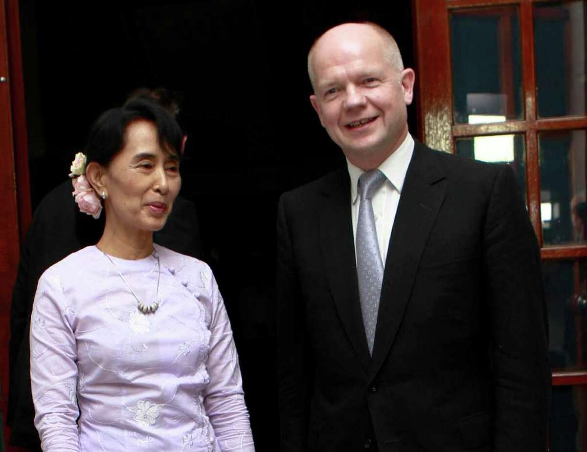 British Foreign Secretary William Hague, right, welcomes Myanmar's pro-democracy leader Aung San Suu Kyi on her arrival to attend a dinner at British ambassador's residence in Yangon, Myanmar, Thursday, Jan. 5, 2012. Hague is the first British foreign secretary to visit Myanmar since 1955. Though Hague's two-day visit signals a shift in relations, Britain won't promise any immediate change in European Union sanctions on arms sales, asset freezes and travel bans, or change a policy that discourages U.K. businesses from trade with Myanmar. (AP Photo/Khin Maung Win)