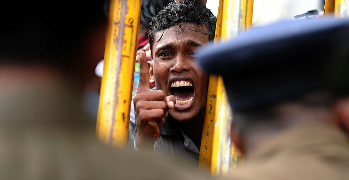 TOPSHOTS Sri Lankan university students protest in Colombo on January 5, 2011. Students were asking authorities to remove vice chancellor N.L.A Karunaratne of the Sri Jayawardenepura university. AFP PHOTO/ ISHARA S. KODIKARA (Photo credit should read Ishara S.KODIKARA/AFP/Getty Images)
