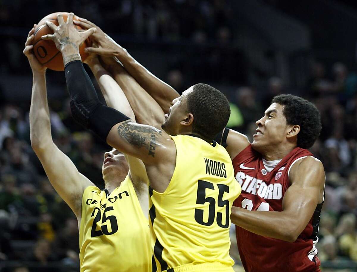 Oregon's E.J. Singler (25) and teammate Tony Woods (55) battle with Stanford's Josh Huestis (24) for a rebound during the first half of an NCAA college basketball game on Thursday, Jan. 5, 2012, in Eugene, Ore. (AP Photo/Rick Bowmer)