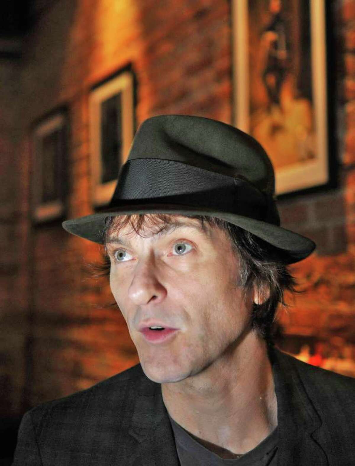 Tommy Stinson, a new resident of Hudson and former bassist in The Replacements, sits inside a Warren Street restaurant in Hudson in late September shortly before hitting the road on his latest assignment. Stinson is now playing with Guns n Roses on its worldwide tour. (John Carl D'Annibale / Times Union)