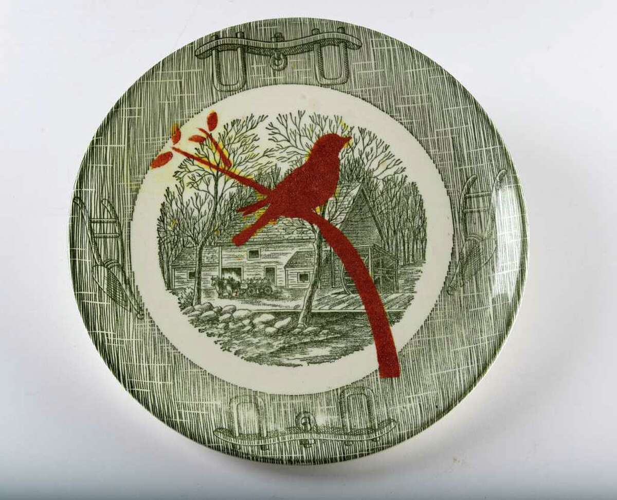 PUT A BIRD ON IT: A stenciled old plate has a singing-bird design.