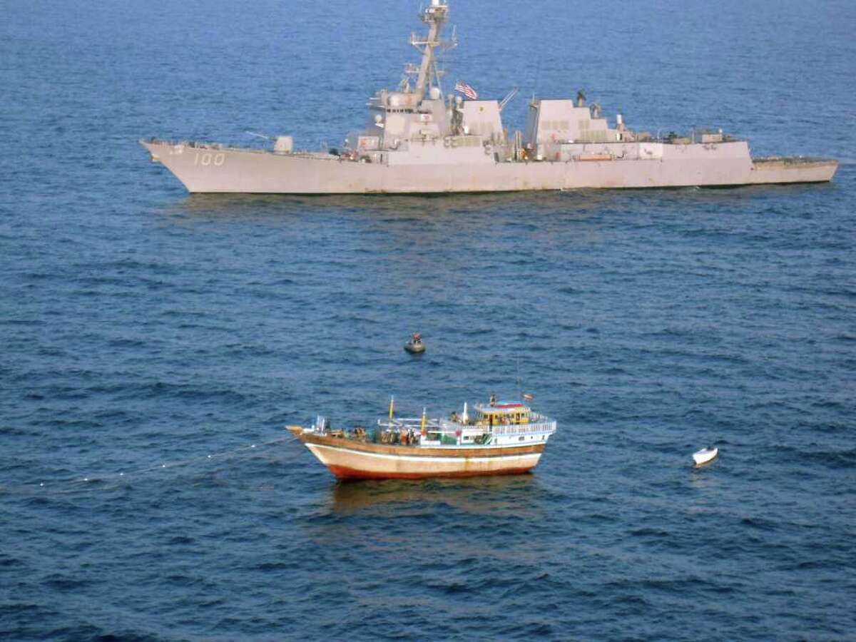 The guided-missile destroyer USS Kidd responds to a distress call from the master of the Iranian-flagged fishing dhow Al Molai. An American team boarded the ship and detained 15 pirates, saving the crew.