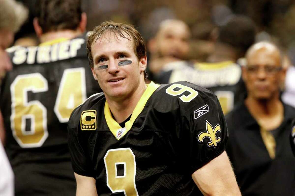 New Orleans Saints quarterback Drew Brees (9) celebrates after breaking Dan marino's all time season passing record in the fourth quarter of an NFL football game against the Atlanta Falcons in New Orleans, Monday, Dec. 26, 2011. (AP Photo/Rusty Costanza)
