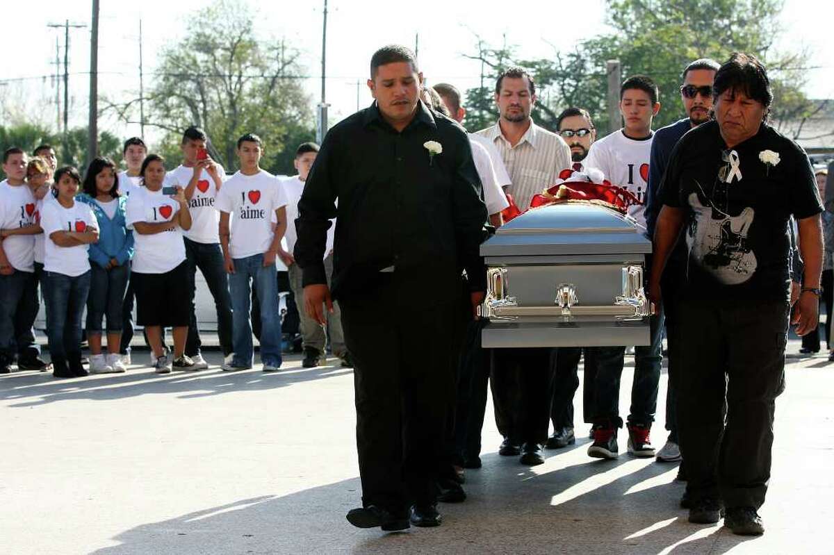 A somber Jaime Gonzalez Sr., center, helps carry his son's casket before the funeral Saturday. "We won't rest until the truth comes out," he later said.