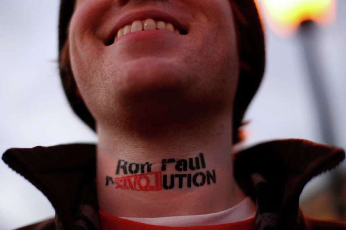 Landon Cook, of Boston, wears his political sentiments on his neck Saturday outside an event for another of the Republican presidential candidates, former Massachusetts Gov. Mitt Romney.