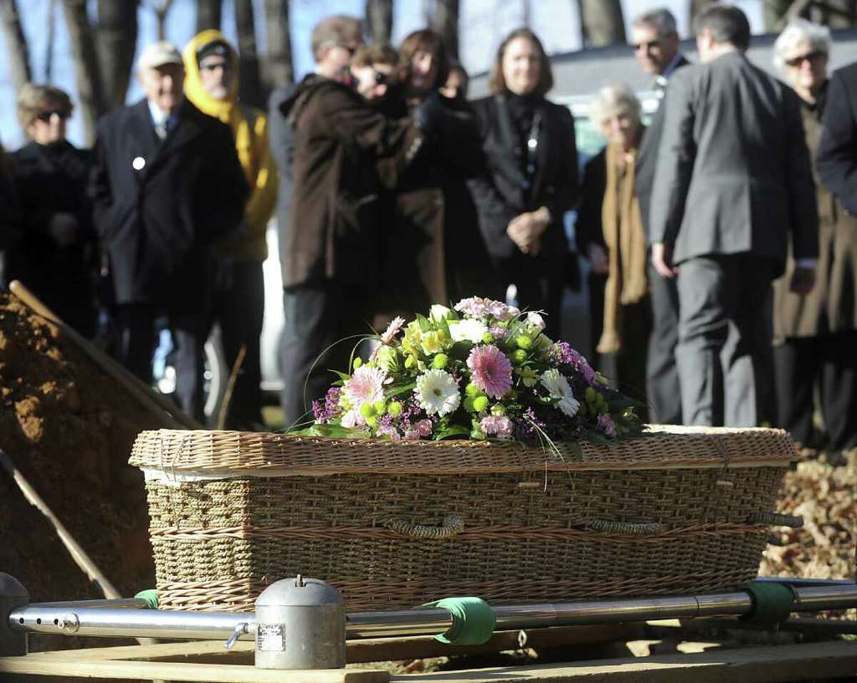 Mourners gather around a seagrass and wicker casket containing Patrick Ytsma's unembalmed body.