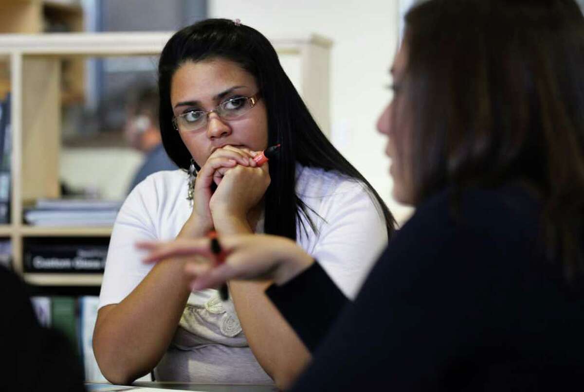 Mariela Lopez, a member of the Highlands High School Engineering, Architecture and Construction Team, listens to Pfluger architect Robyn Popa during a meeting to give ideas for the bond funded renovation of the high school. Wednesday, Nov. 30, 2011. Photo Bob Owen/rowen@express-news.net