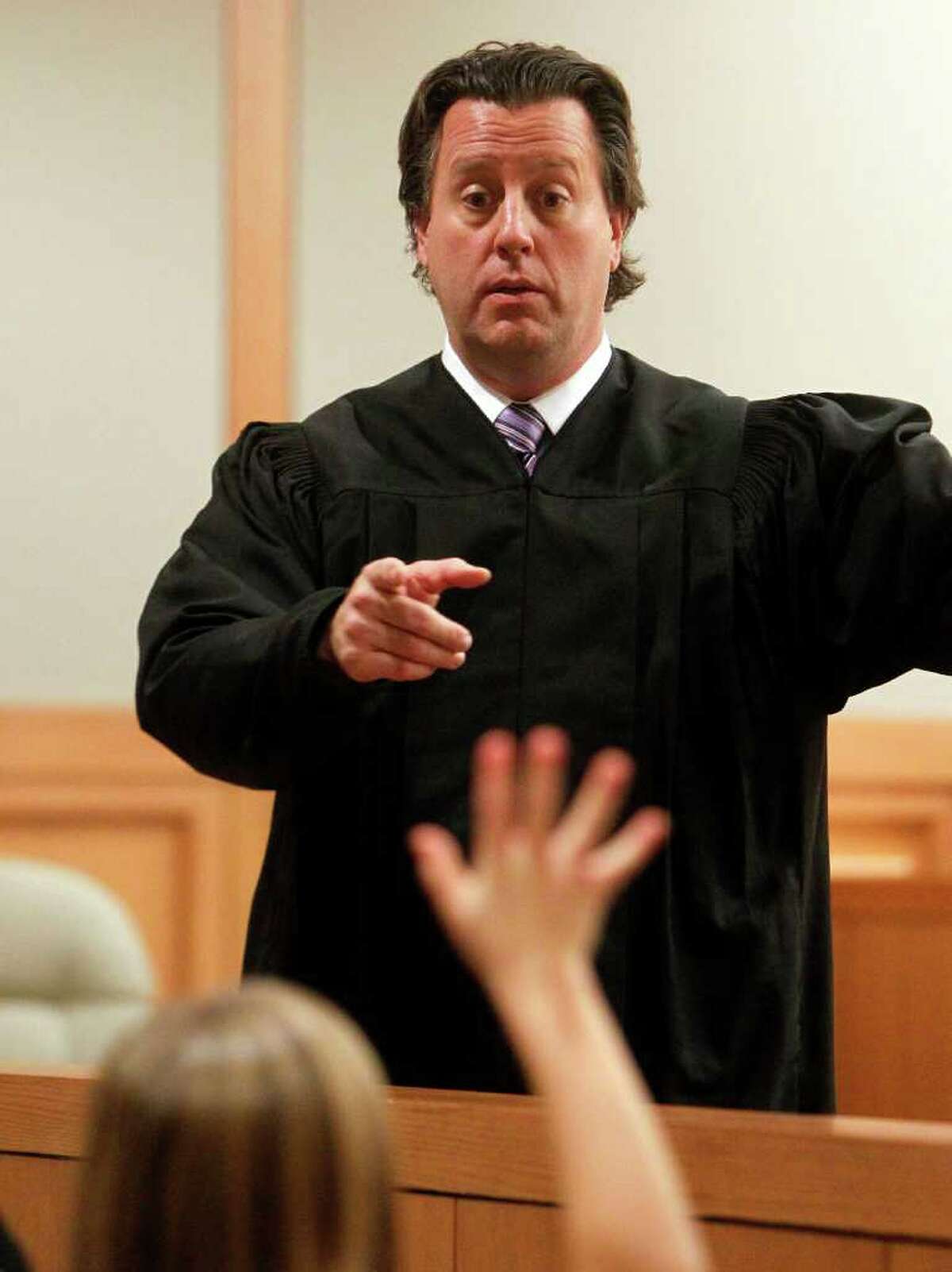 FOR USE MONDAY, JAN. 9 AND THEREAFTER - In this Dec. 15, 2011 photo, Judge Chris Oldner answers a question from a child during a mock court session at Collin County Courthouse in McKinney, Texas. The Collin County District Attorney's office and Children's Advocacy Center of Collin County have paired up to help take the fear out of testifying for children involved in felony cases. (AP Photo/The Dallas Morning News, Vernon Bryant) MANDATORY CREDIT; MAGS OUT; TV OUT; INTERNET OUT; AP MEMBERS ONLY