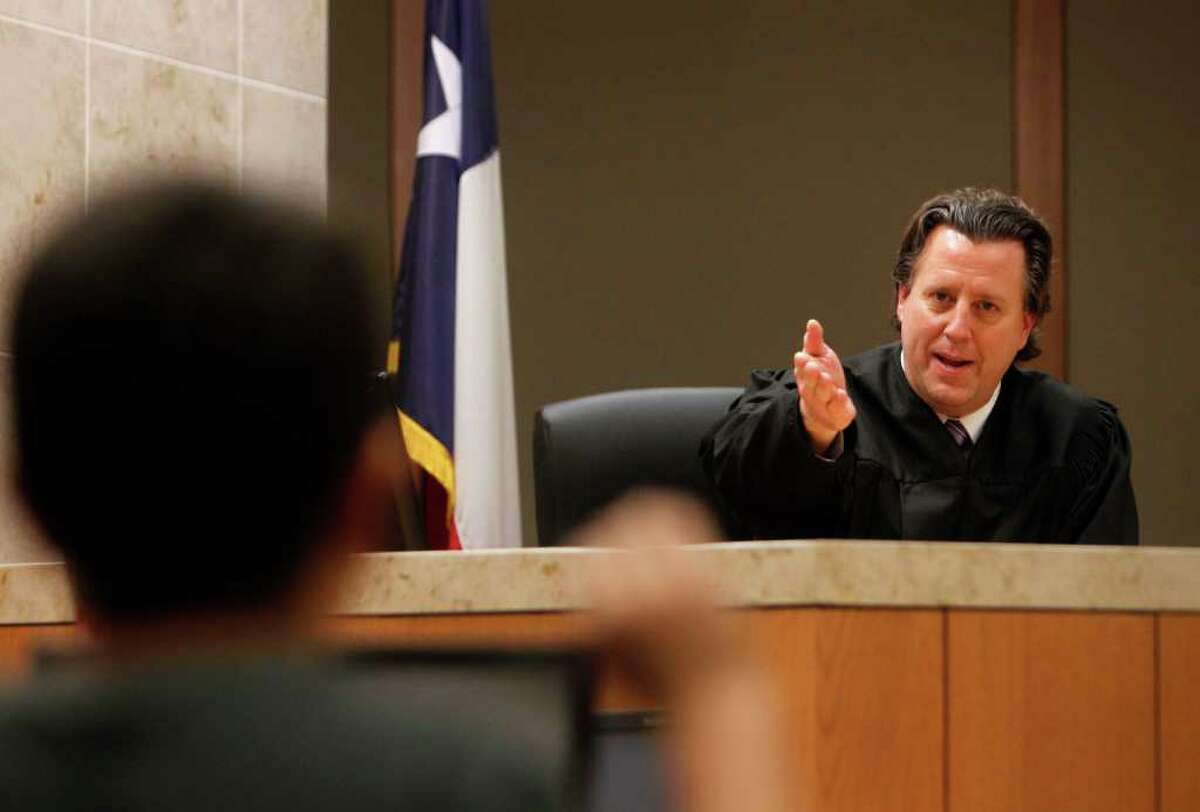 Judge Chris Oldner swears in a child last month during a mock court session at the Collin County Courthouse in McKinney. The program helps take the fear out of testifying for children involved in felony cases.