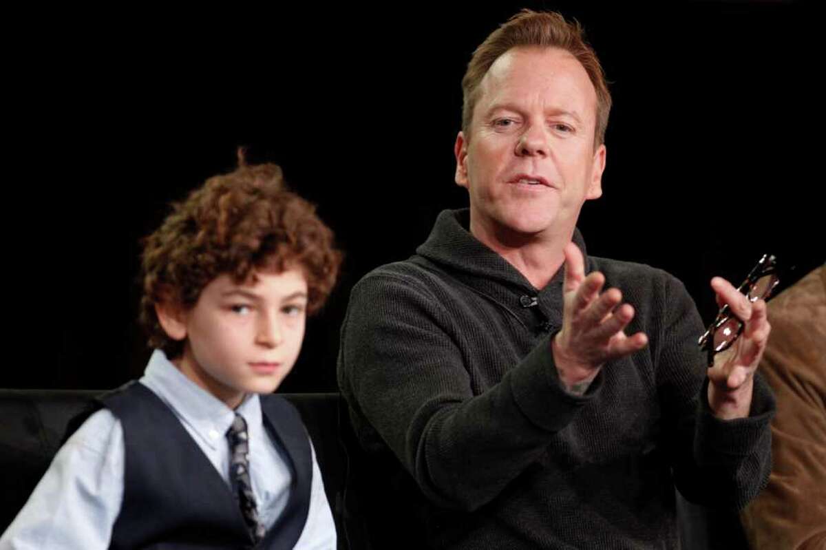 Executive producer and cast member Kiefer Sutherland, right, answers a question next to co-star David Mazouz during the panel discussion for the Fox television show "Touch" at the Fox Broadcasting Company Television Critics Association Winter Press Tour in Pasadena , Calif., on Sunday, Jan. 8, 2012. (AP Photo/Danny Moloshok)