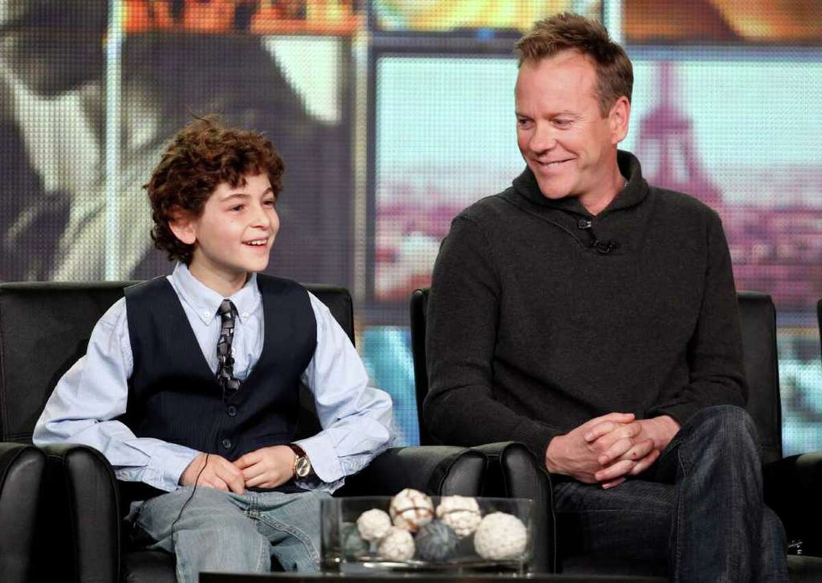 Executive producer and cast member Kiefer Sutherland, right, and co-star David Mazouz smile during the panel discussion for the Fox television show "Touch" at the Fox Broadcasting Company Television Critics Association Winter Press Tour in Pasadena, Calif., on Sunday, Jan. 8, 2012. (AP Photo/Danny Moloshok)