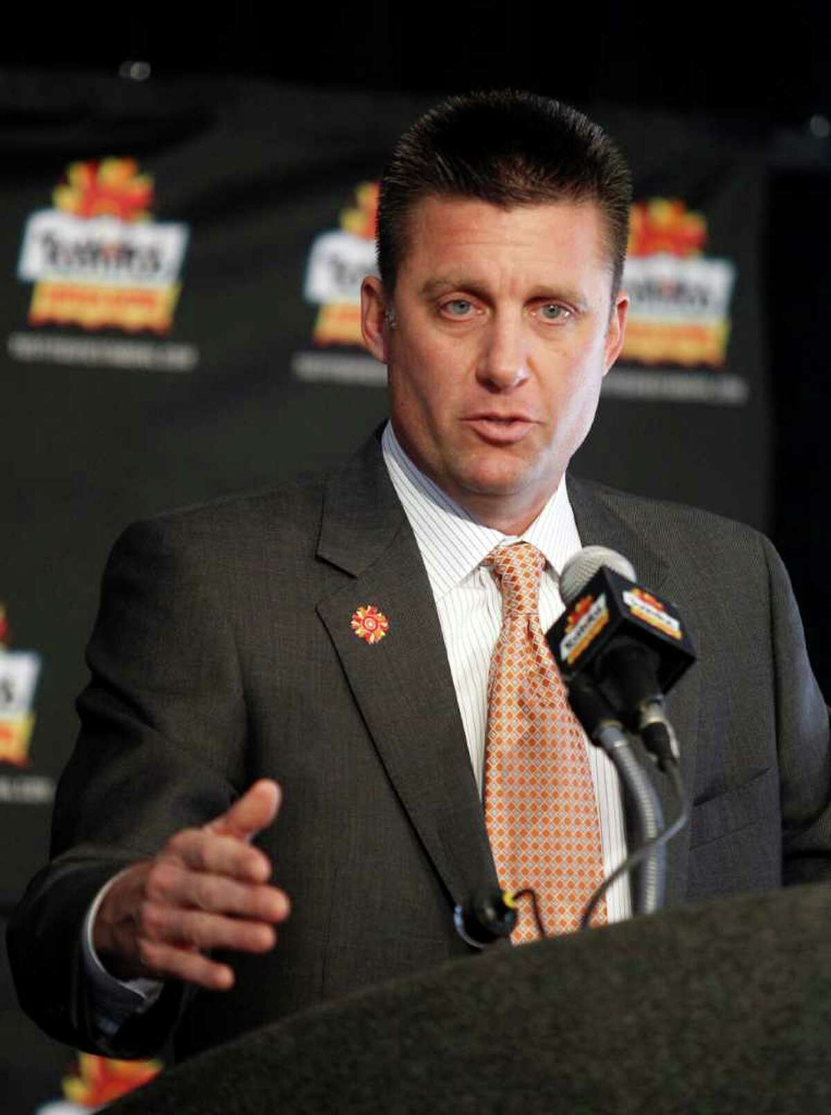 Oklahoma State coach Mike Gundy answers questions during a news conference upon the team's arrival to play Stanford in the Fiesta Bowl NCAA college football game Jan. 2 on Monday, Dec. 26, 2011, at Sky Harbor International Airport in Phoenix. (AP Photo/Paul Connors)