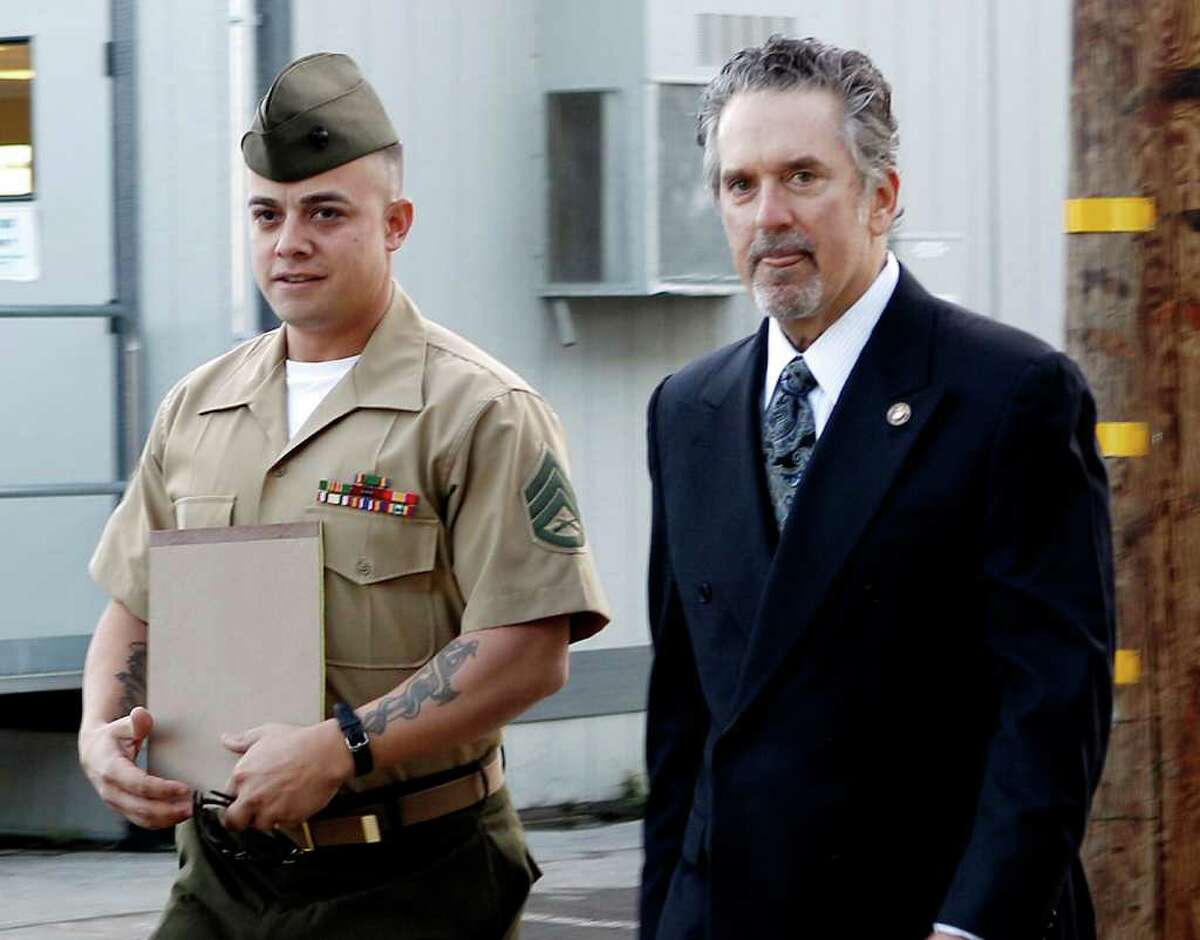 FILE - In this Jan. 5, 2012 file photo, United States Marine Staff Sgt. Frank Wuterich arrives at a court room at Camp Pendleton with lead defense attorney Neal Puckett in Camp Pendeton, Calif. Opening arguments in Wuterich's will be Monday, Jan. 9, 2012 _ more than six years after his Marine squad in 2005 killed 24 Iraqis, including unarmed women and children in the town of Haditha. (AP Photo/Lenny Ignelzi, File)