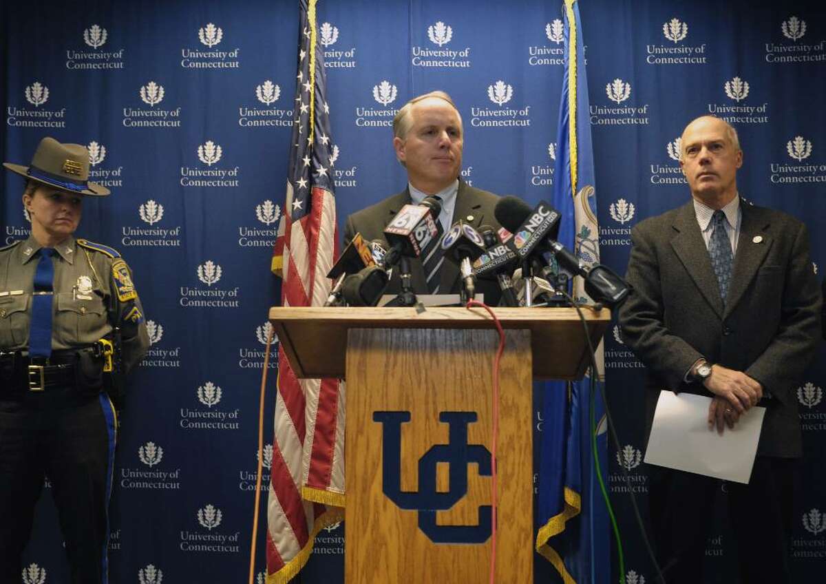Robert S. Hudd, center, Chief of Police for the University of Connecticut Police Department, makes an announcement of an arrest in the murder of Connecticut football player Jasper Howard during a news conference on Tuesday, Oct. 27, 2009 in Storrs, Conn. Connecticut Department of Public Safety Commissioner John A. Danaher III, right, looks on. Howard, a starting cornerback on the football team, was stabbed early Oct. 18 outside a university-sanctioned dance, hours after helping his team to a homecoming game win over Louisville. Police arrested three men, John W. Lomax III of Bloomfield, Hakim Muhammad of Bloomfield, and Jamal Todd of Hartford in connection with the death of UConn football player Jasper Howard. (AP Photo/Jessica Hill)