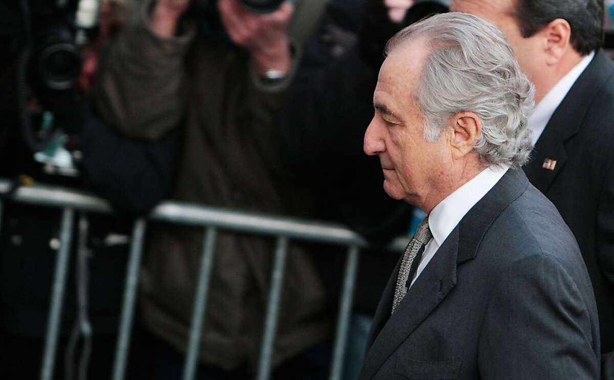 NEW YORK - MARCH 12: Disgraced financier Bernard Madoff passes a police barricade as he arrives at court March 12, 2009 in New York City. Madoff was expected to plead guilty to all 11 felony charges brought by prosecutors on financial misdoings, and could end up with a sentence of 150 years in prison. (Photo by Chris Hondros/Getty Images)