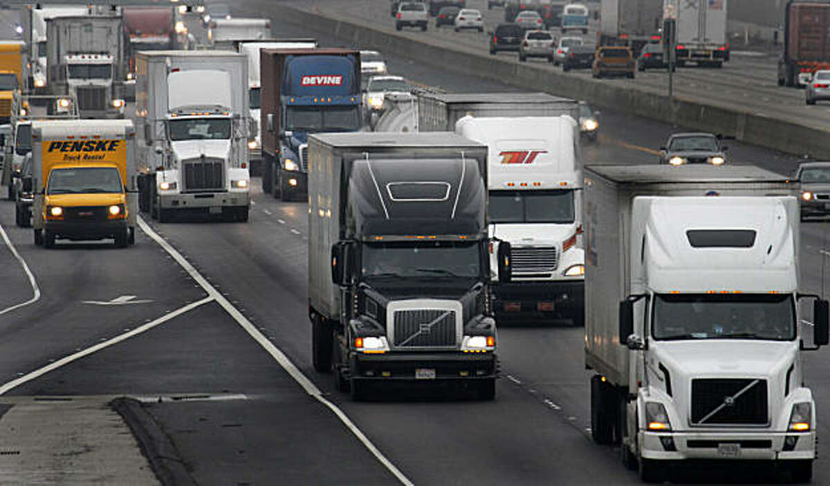 Trucks make their way on eastbound I-580 Friday, Dec. 17, 2010, in Livermore, Calif. Businesses will have more time to comply with California's tough diesel emissions standards for trucks, buses and construction equipment under new, relaxed rules expectedto be adopted by air quality officials.