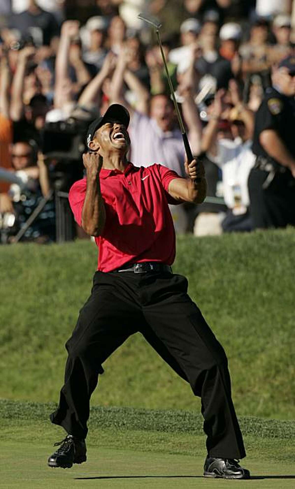 This is a June 15, 2008, file photo showing Tiger Woods reacting after sinking a birdie putt on the 18th green forcing a playoff against Rocco Mediate during the fourth round of the US Open championship at Torrey Pines Golf Course in San Diego. The only measure of golf is the score on the card. Woods had the lowest score 54 times on the PGA Tour this decade, including 12 majors. He won at a staggering rate of 30 percent, with nine victories by at least eight shots. Such dominance is what makes Woods a candidate for The Associated Press' Athlete of the Decade.