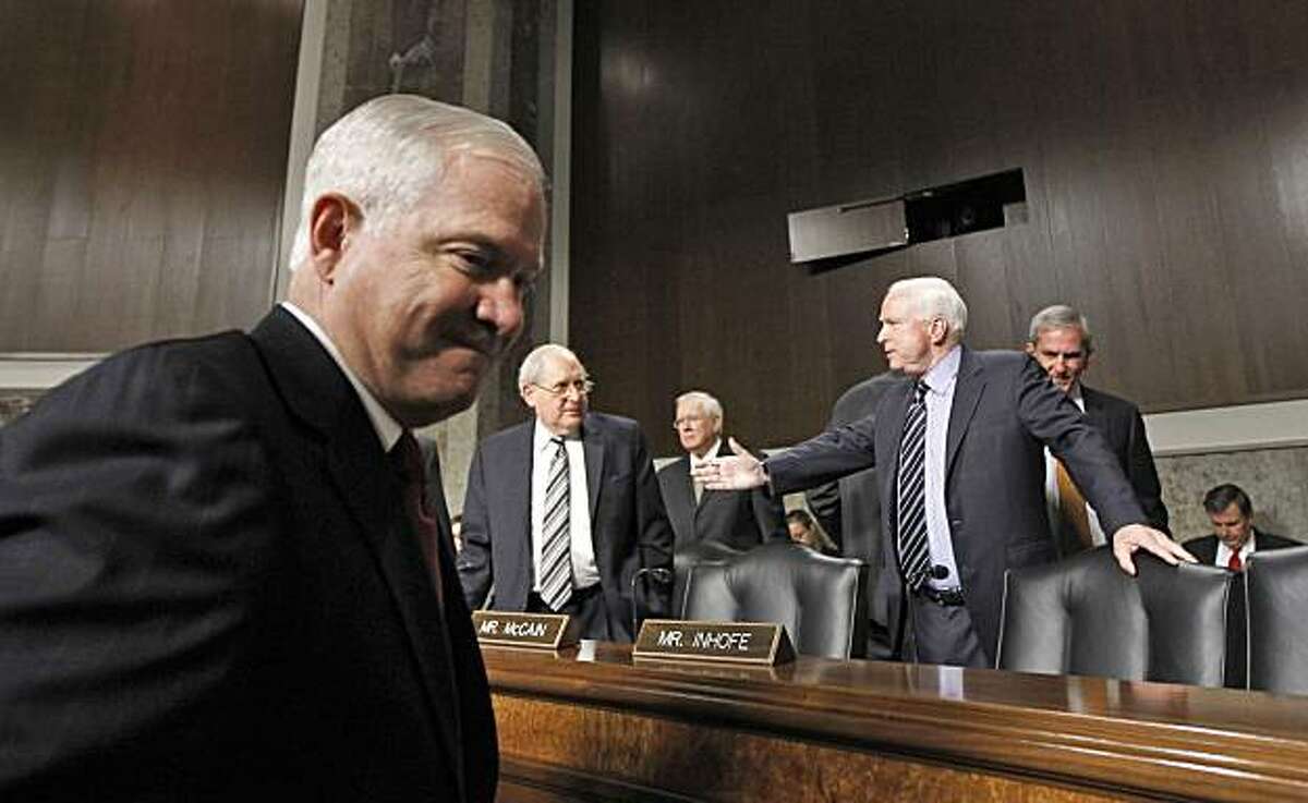 Defense Secretary Robert Gates, left, arrives on Capitol Hill in Washington Thursday, Dec. 2, 2010, to testify before the Senate Armed Services Committee hearing about the Don't Ask Don't Tell policy. Committee Chairman Sen. Carl Levin, D-Mich., is at center, the committee's ranking Republican Sen. John McCain, R-Ariz. is at left.