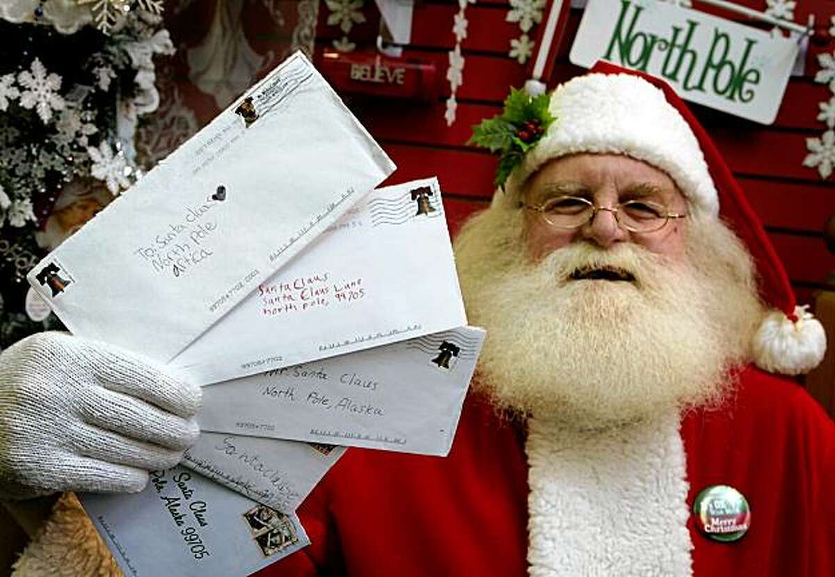 Santa Claus, also known as Patrick Farmer, at Santa Claus House in North Pole, Alaska Wednesday Nov. 18, 2009, holds letters from children sent this year that the U.S. Postal Service says they will no longer deliver. Citing privacy concerns, postal officials say that generically addressed letters to "Santa Claus, North Pole" will no longer be forwarded to volunteers in the Alaska town as has been done for years.