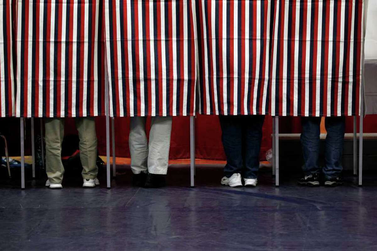 Voters mark their ballots on Tuesday, Jan. 10, 2012, during voting in the first-in-the-nation presidential primary, at Memorial High School in Manchester, N.H.