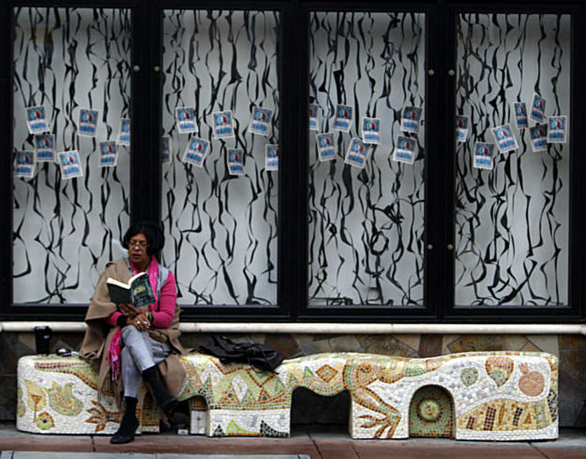 Angelina Toscano takes a break from office work to read a book on a custom painted artisan bench on Berkeley's Addison Street. Friday Jan 23, 2009