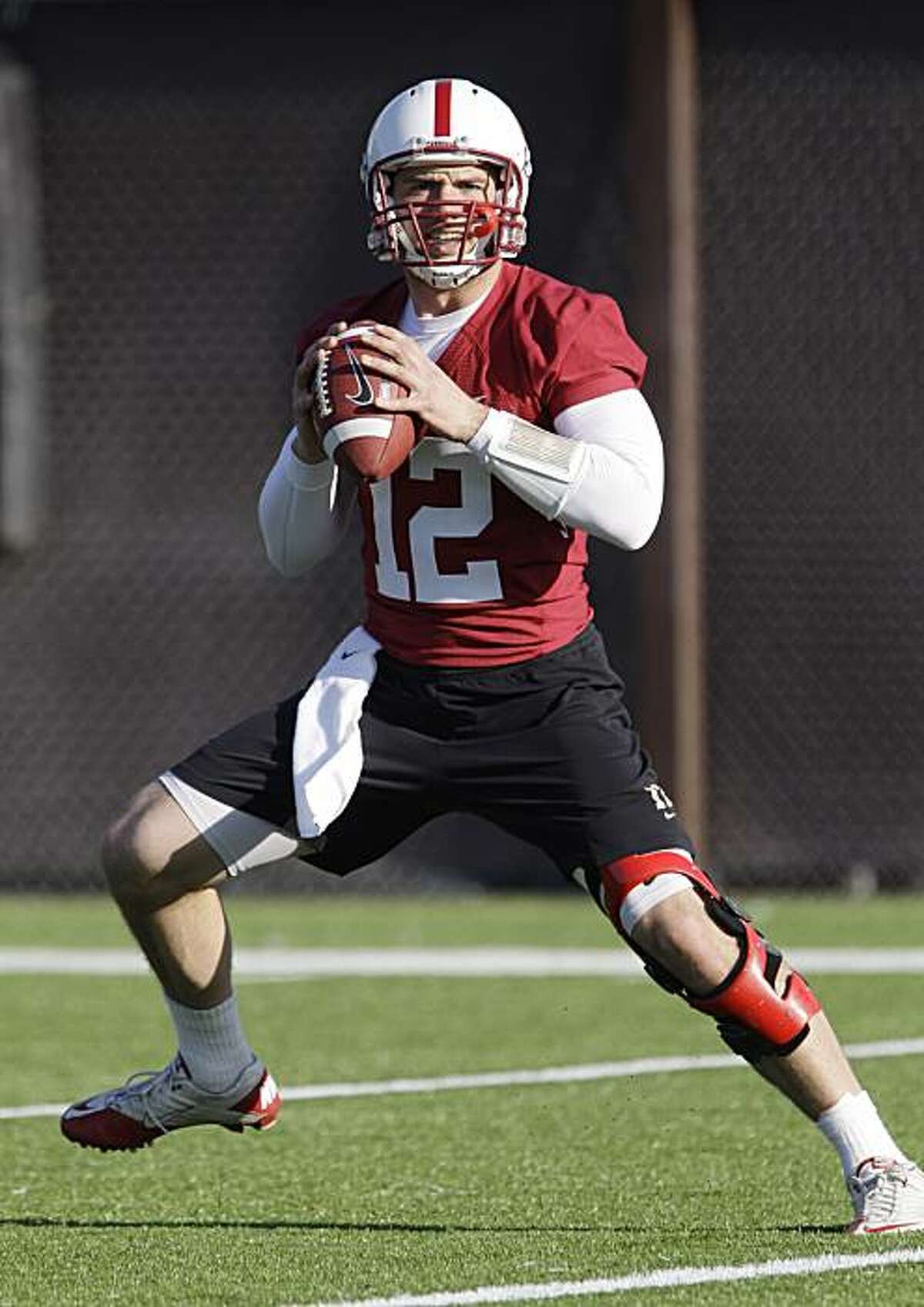 This photo made Feb. 23, 2011, shows Stanford quarterback Andrew Luck painges during an NCAA college football practice on the Stanford University campus in Stanford, Calif. Luck knows there will be a ton of pressure and pageantry that will follow him next fall as the presumptive Heisman Trophy favorite. He still has no regrets about returning to the Cardinal or turning down being the likely No. 1 pick in the NFL draft this year.