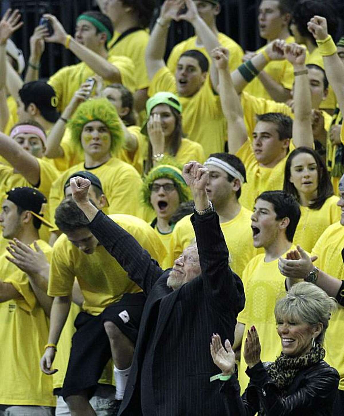 Nike co-founder and Ducks benefactor Phil Knight and his wife, Penny, celebrate Oregon's victory over Southern California during an NCAA basketball game Thursday, Jan. 13, 2011, in Eugene, Ore. Oregon defeated USC 68-62. (AP Photo/Rick Bowmer)