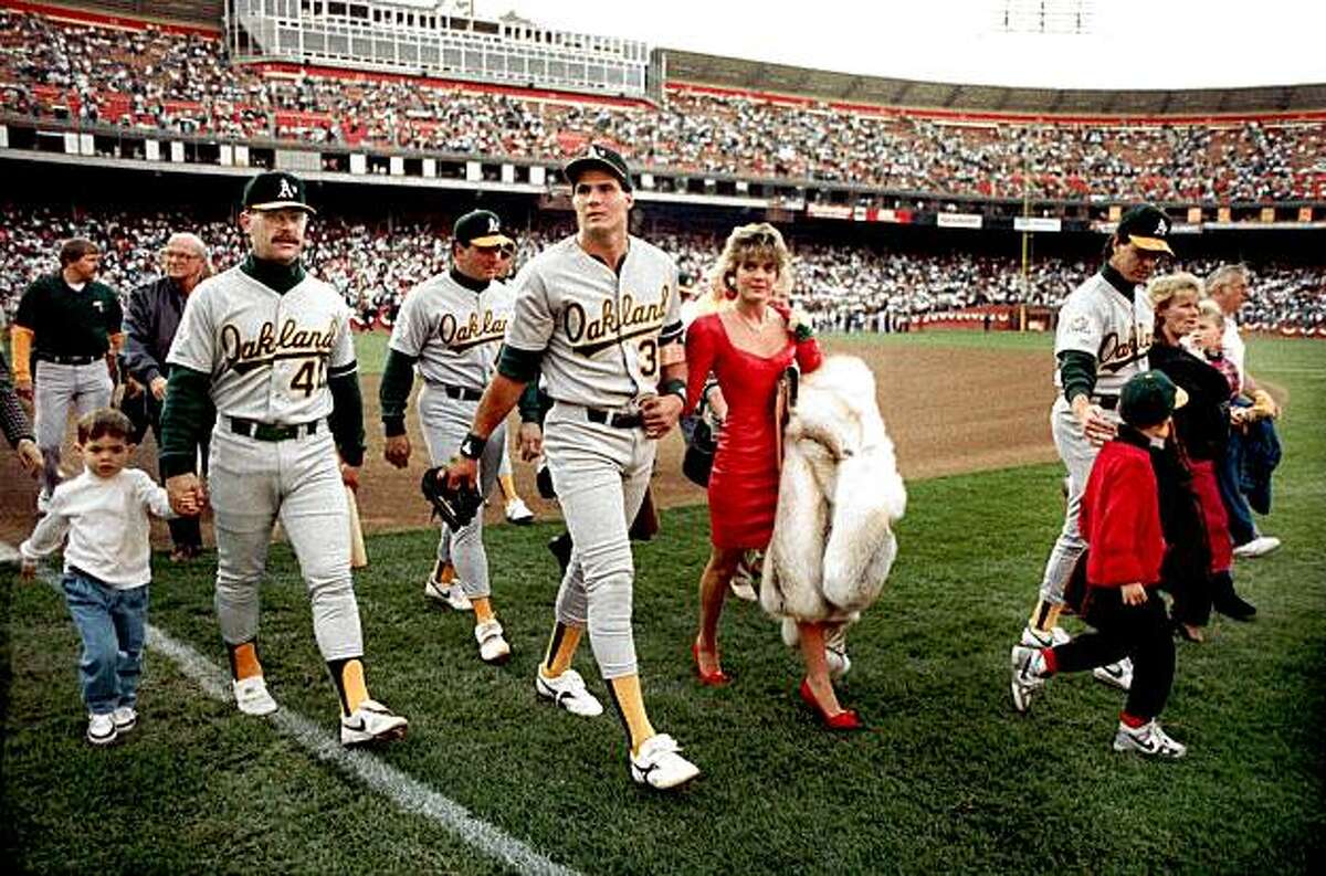 In this photo taken October 17, 1989, Oakland A's Jose Canseco walks off the field with his wife Ester and other A's players before the start of the World Series at Candlestick Park in San Francisco.