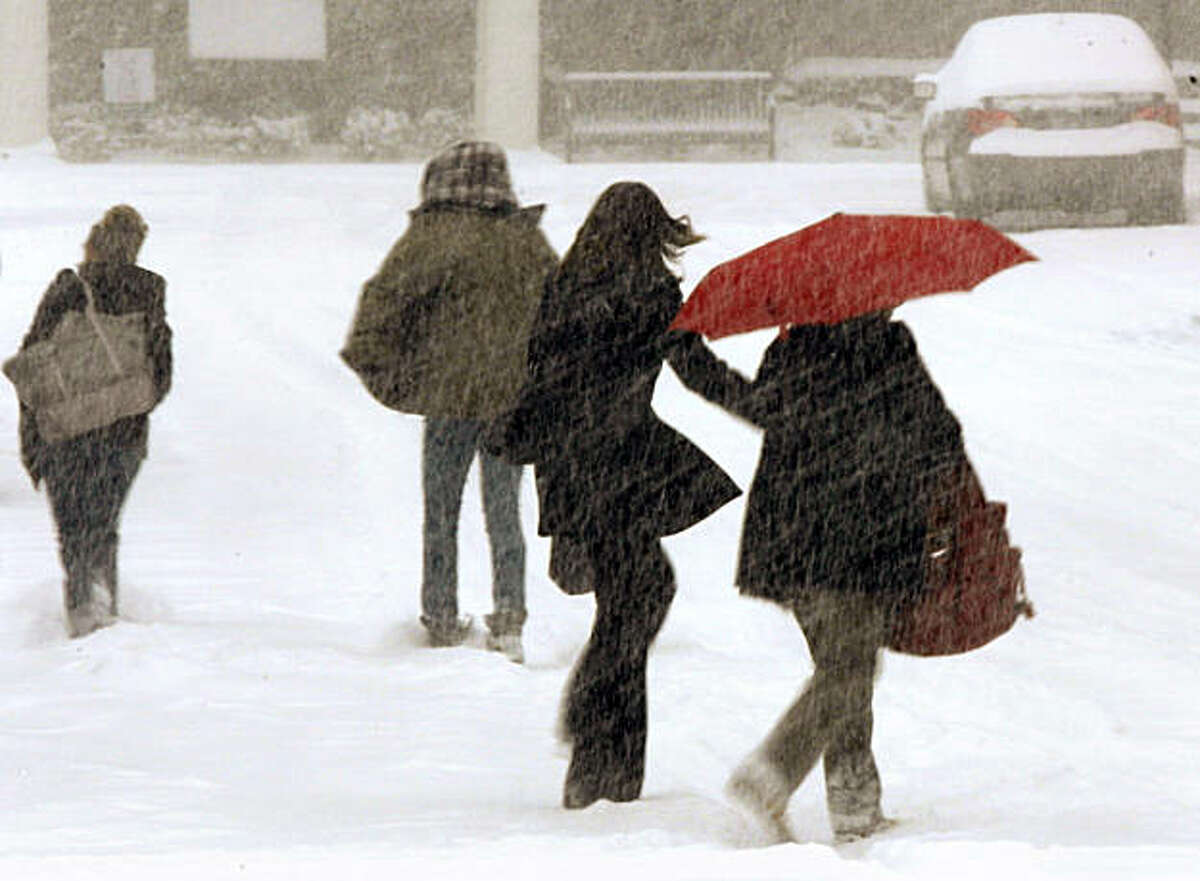 Four girls cross a snow-covered street in Little Rock, Ark., Wednesday, Feb. 9, 2011. A winter storm dropped nearly two feet of snow on parts of Arkansas on Wednesday after forecasters predicted that only a half-foot or so would fall.