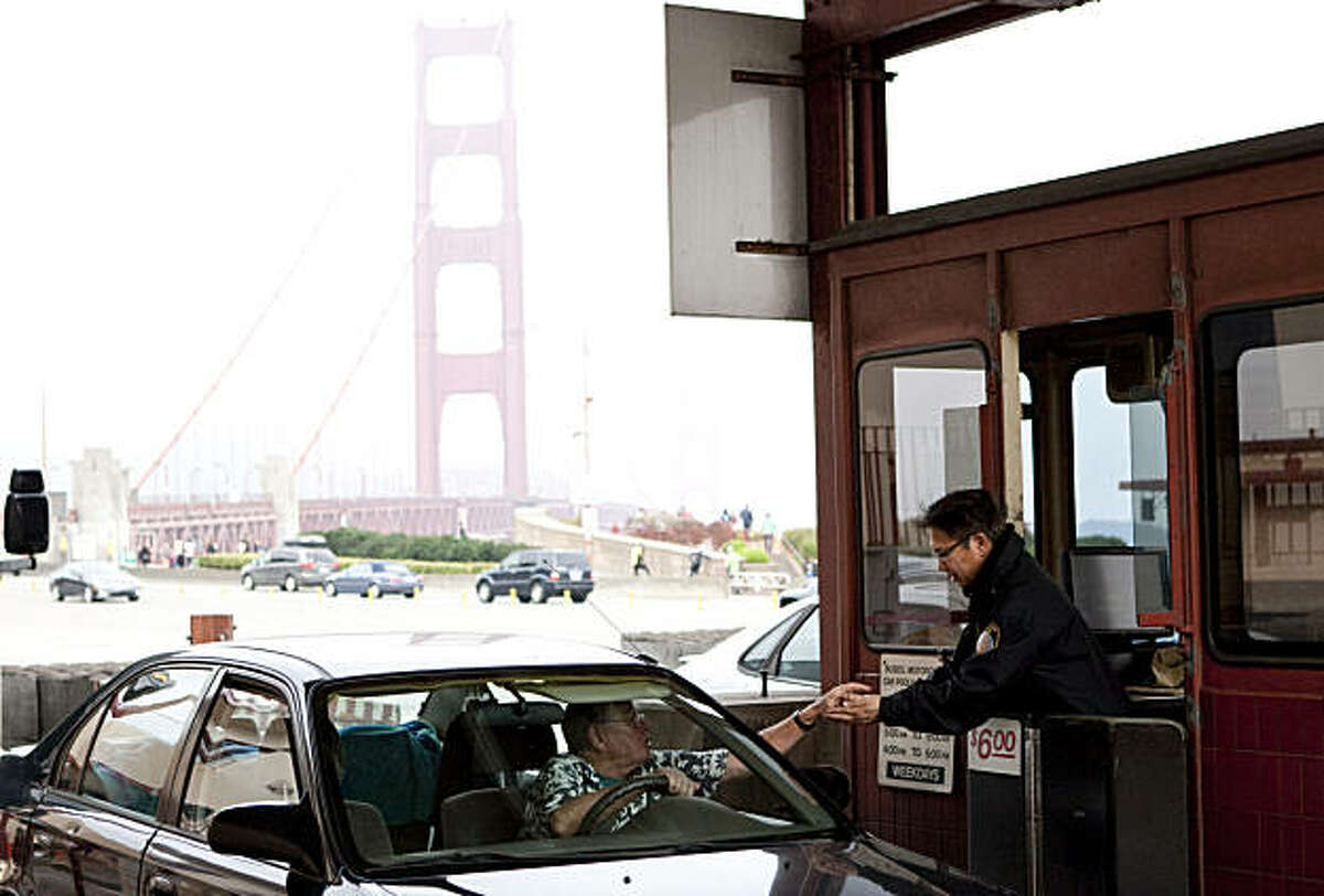 Ben Ramirez collects a toll from a motorist while working at the Golden Gate Bridge in San Francisco, Calif., on Friday, January 28, 2011. Starting in 2012, the bridge will no longer be using toll takers and will move to an all-electronic system.