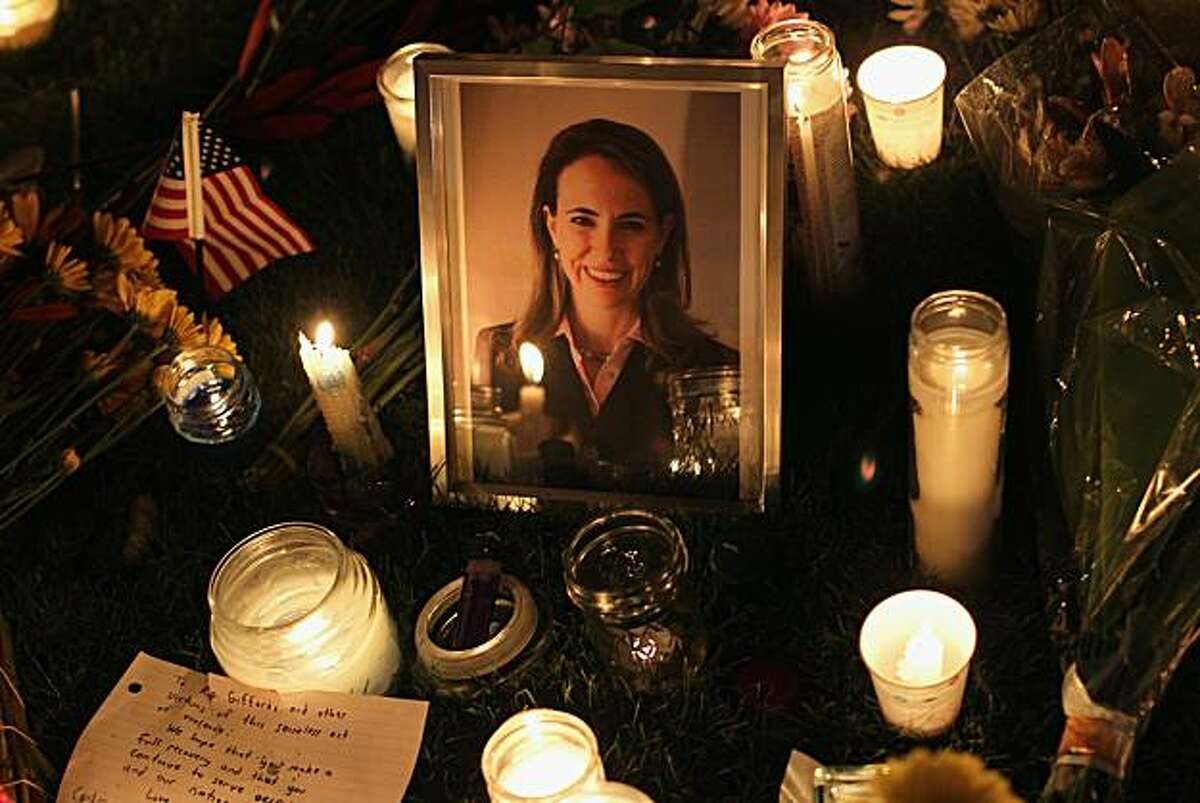 TUCSON, AZ - JANUARY 08: Candles surround a portrait of U.S. Rep. Gabrielle Giffords (D-AZ), who was shot January 8, 2011 in Tuscon, Arizona. Giffords was shot in the head at a public event entitled "Congress on Your Corner" when a gunman opened fire outside a Safeway grocery store in Tucson. It was reported that eighteen people were shot, including members of Giffords' staff, and six are dead, including one young child. One suspect is in custody.