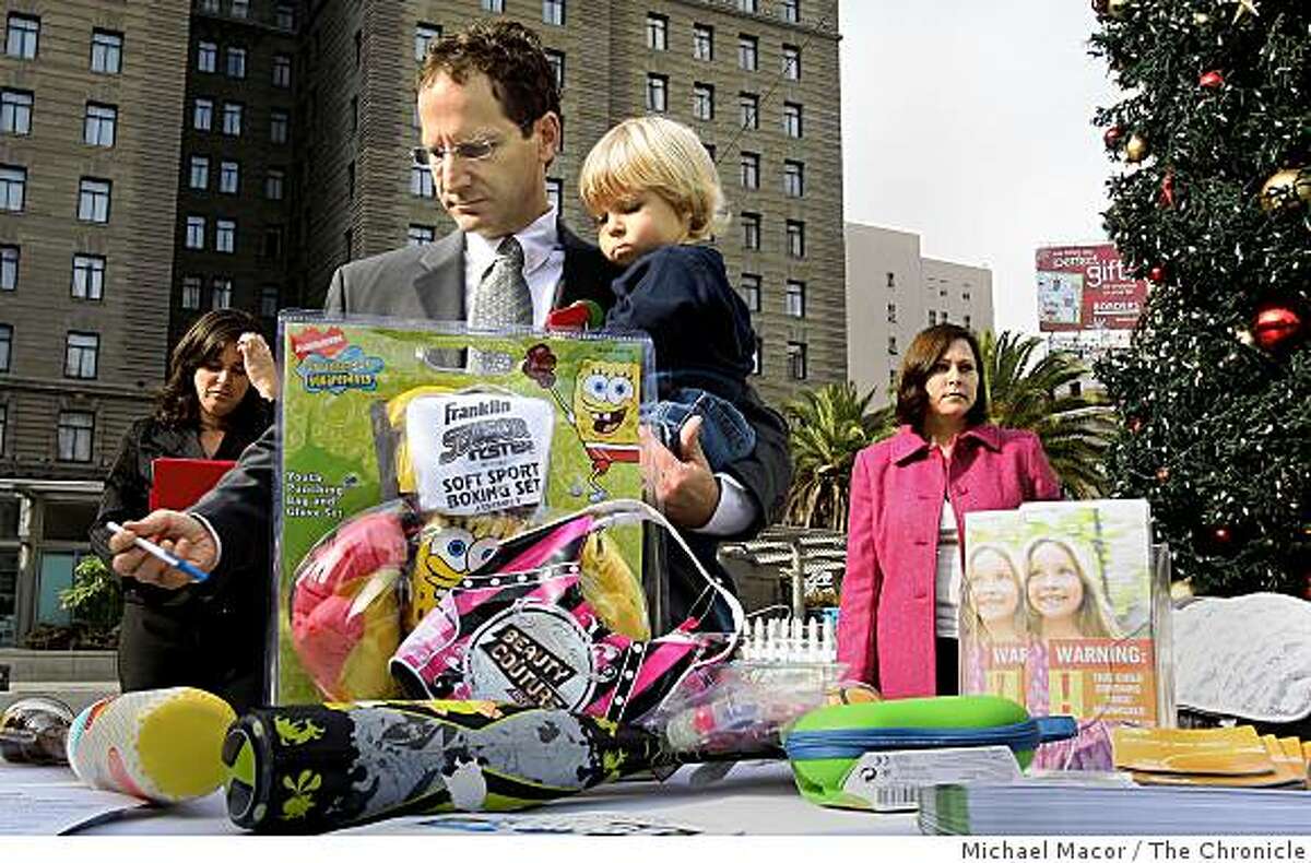 Executive Director, Michael Green, of the Oakland-based Center for Environmental Health, with his son Dylan, 2, displays some of the products with high lead levels are still on store shelves, Wednesday Dec.. 3, 2008 in San Francisco, Calif. Shoppers can visit the Oakland offices of the Center for Environmental Health at 2201 Broadway suite 302 in Oakland, Calif. to have their toys tested for toxic chemicals, Monday-Thursday 12pm-6pm until Christmas Day, for free.