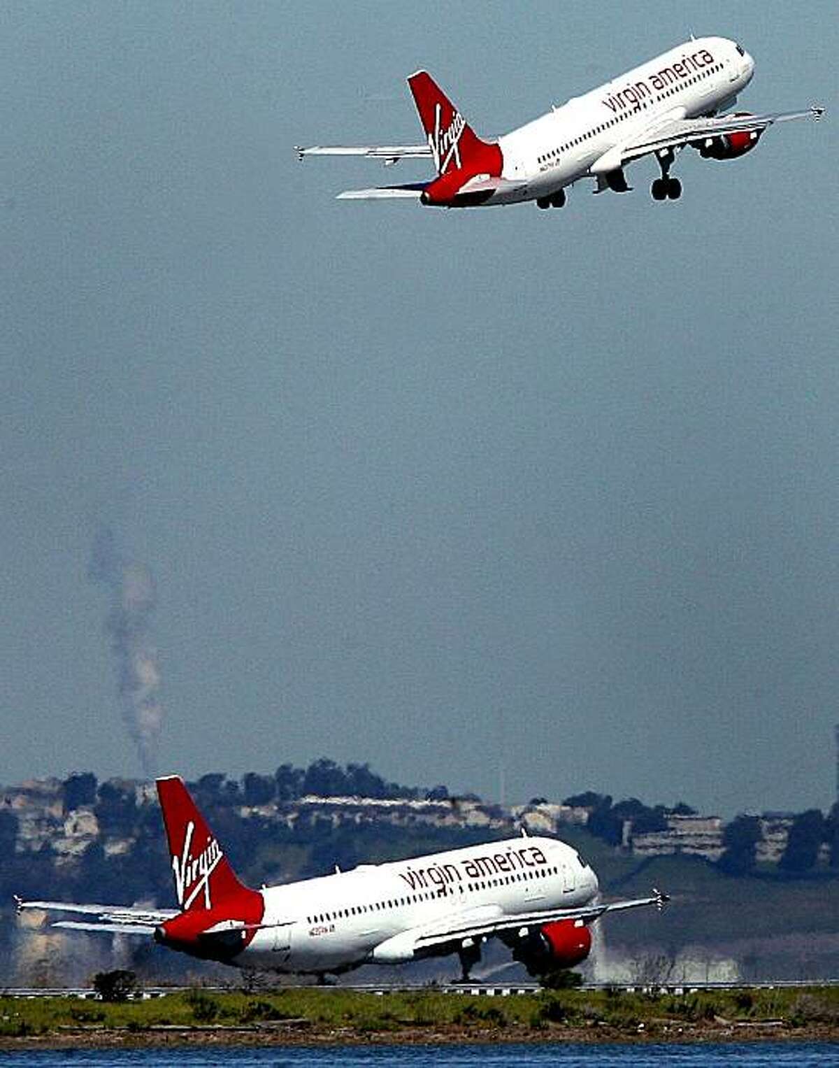 Virgin America airplanes take off from the San Francisco International Airport near Millbrae, Calif. on Tuesday March 10, 2009.