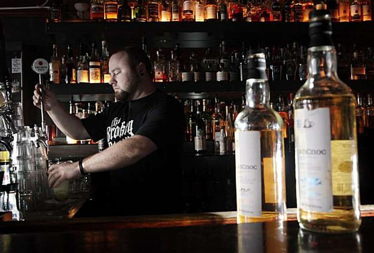 Broken Record owner Jason King preparing a boilermaker on Wednesday, December 22, 2010, at his bar in San Francisco, Calif. The boilermaker he is making is made from Trumer Pilsner with the highland-malt whisky An Cnoc