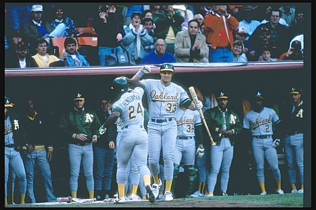 Members of the Rickey Henderson family show off their fans before