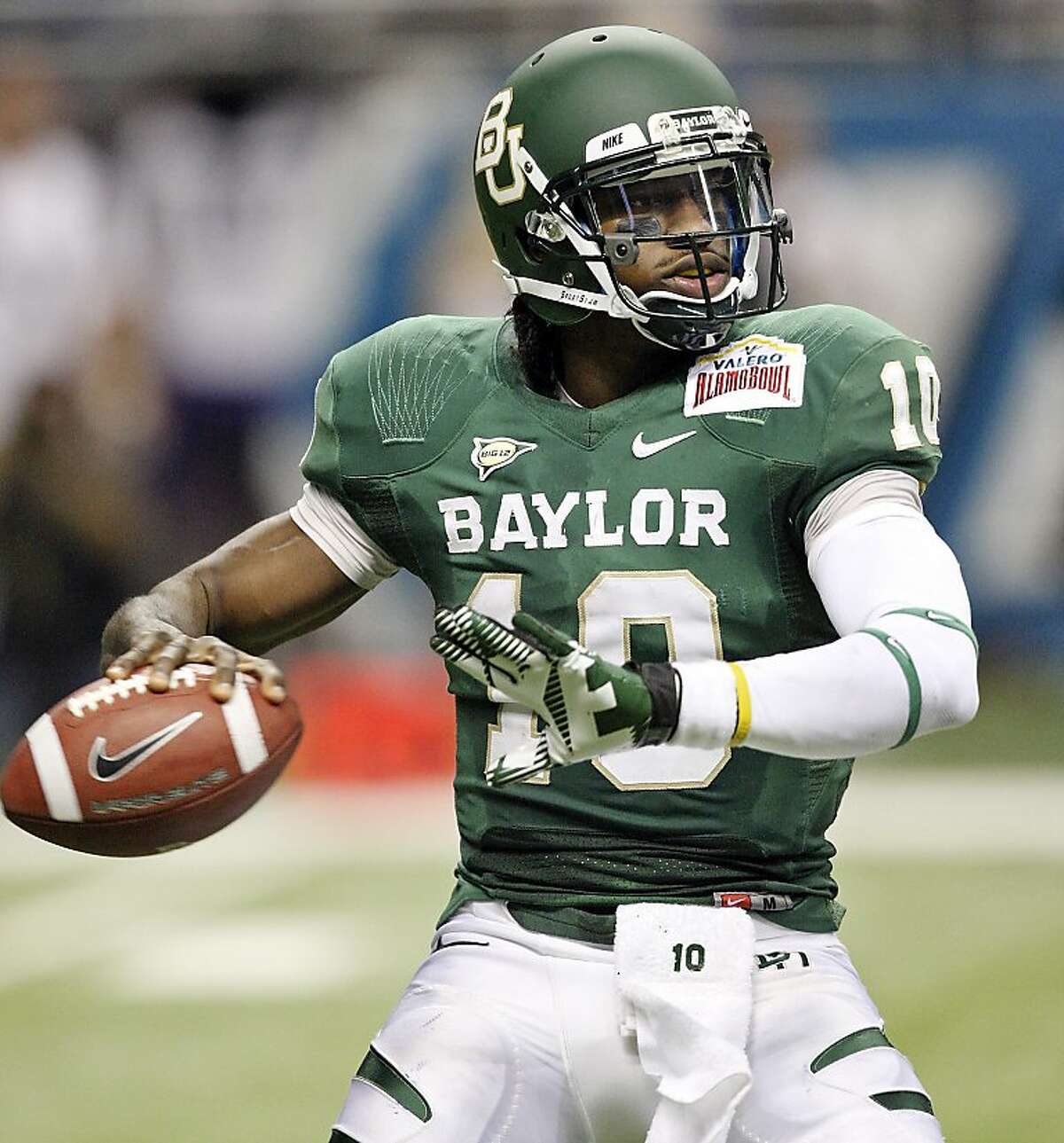 FOR SPORTS - Baylor's Robert Griffin III looks to pass against Washington during first half action of the 2011 Valero Alamo Bowl Thursday Dec. 29, 2011 at the Alamodome in San Antonio,Tx. (PHOTO BY EDWARD A. ORNELAS/eaornelas@express-news.net)