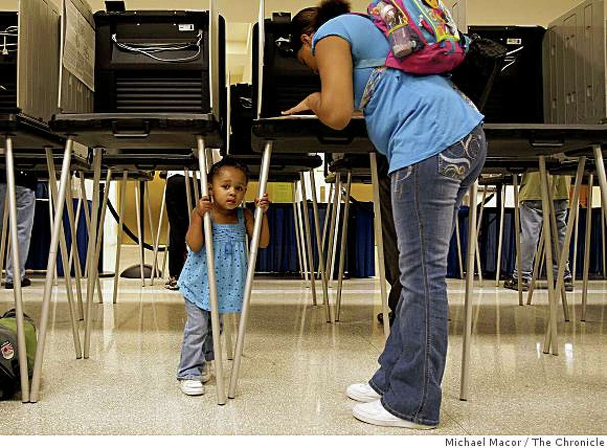 20-year-old Shante Davis, with her two-year-old daughter Shantayjah Wells in tow, votes for the first time in San Francisco City Hall on Thursday Oct. 23, 2008.