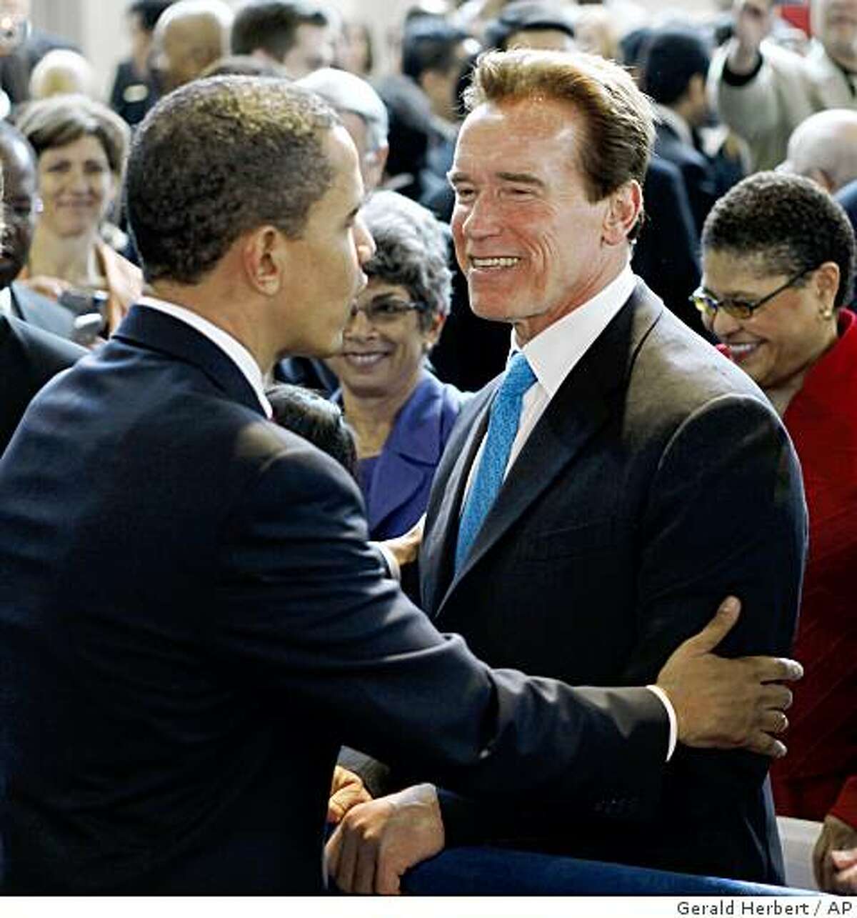 President Barack Obama greets California Gov. Arnold Schwarzenegger after speaking at a town hall meeting at the Miguel Contreras Learning Complex in Los Angeles, Thursday, March 19, 2009. (AP Photo/Gerald Herbert)