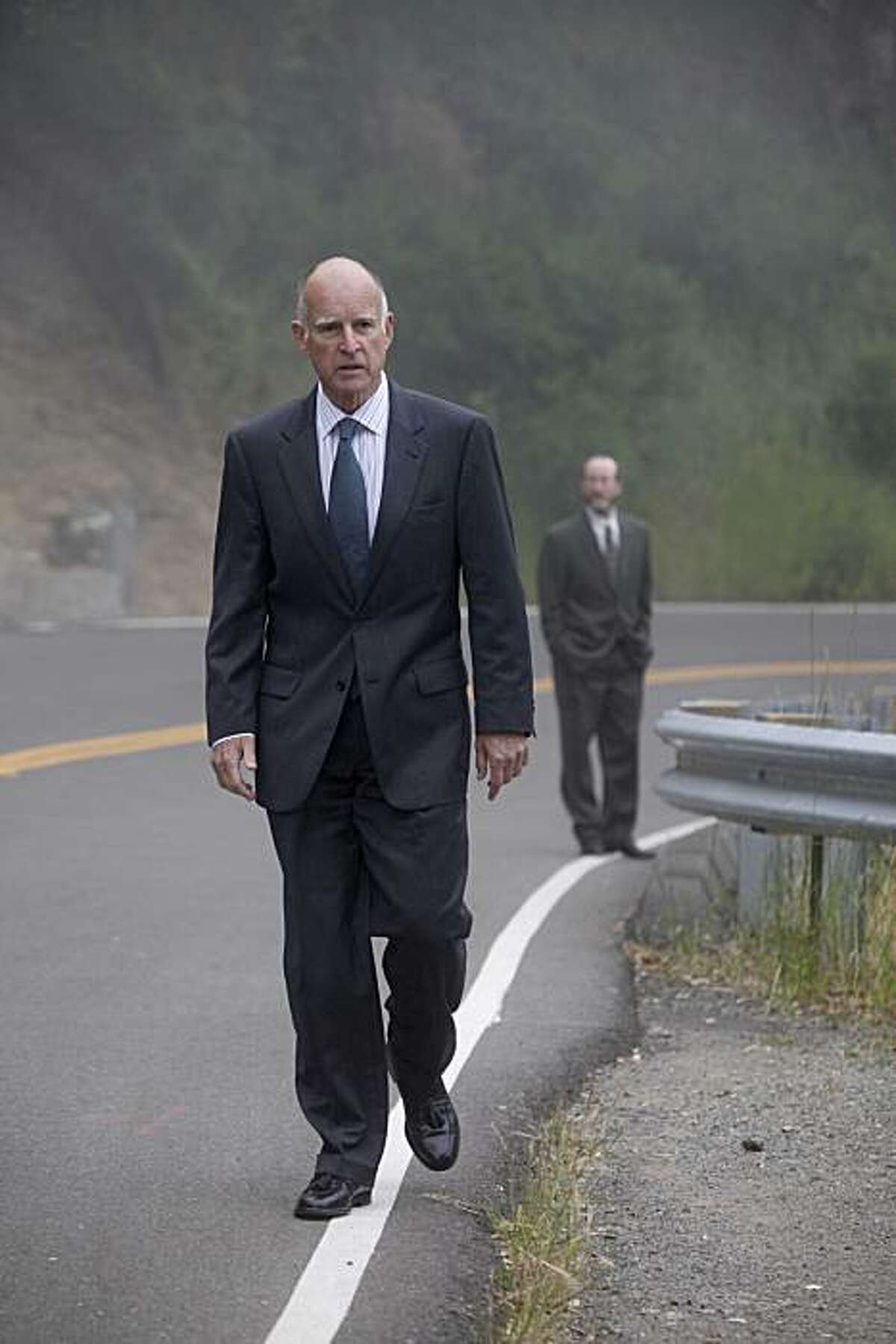 Joined by his campaign manager, Steven Glazer, California Attorney General Jerry Brown walks back to his Oakland hills home after voting in the primary election at Oakland Fire House No. 6 on Tuesday.