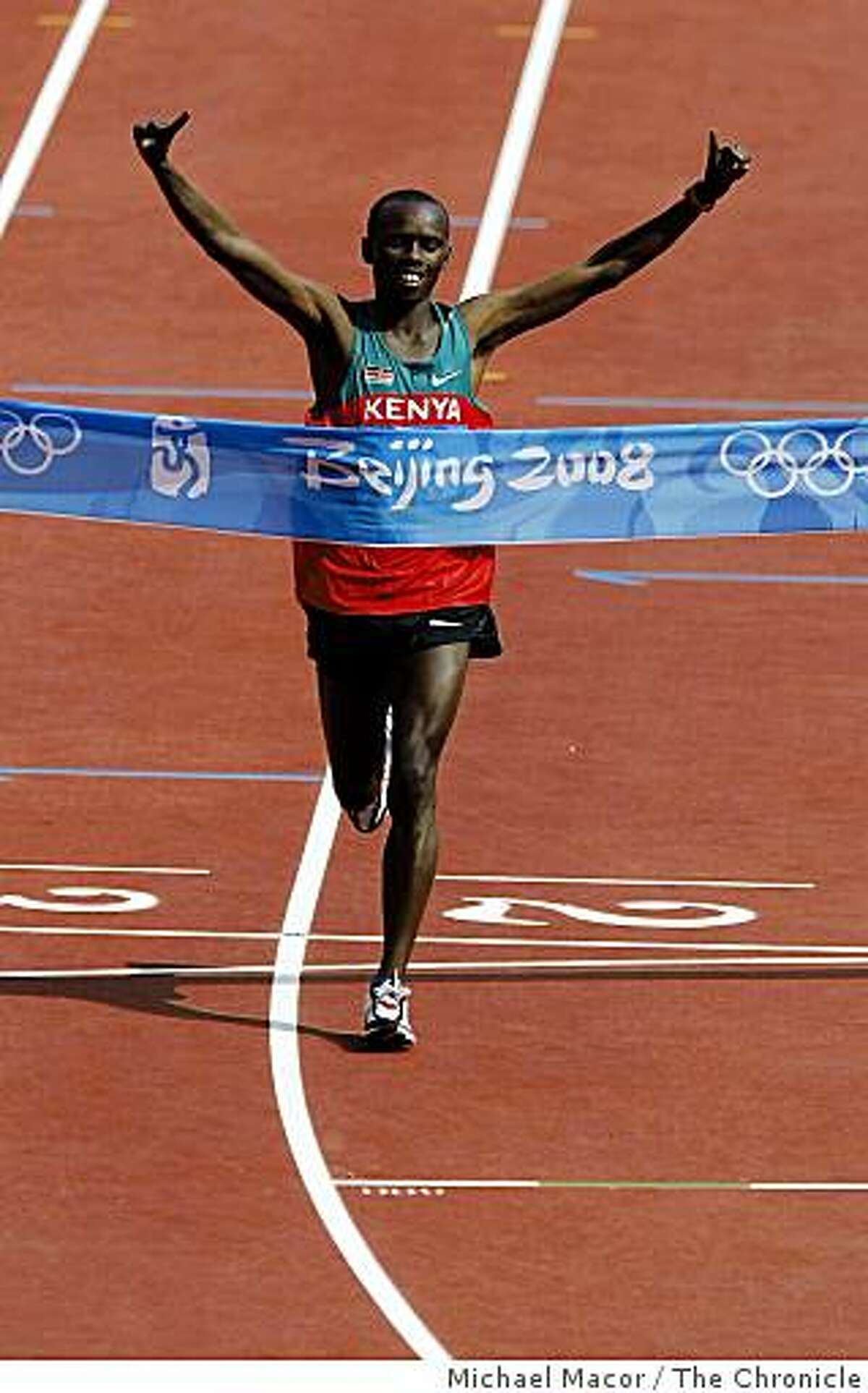 Kenya's, Samuel Kamau Wansiru crosses the line first with a time of 2:06.32 to take the gold medal in the men's Marathon race, at the 2008 Olympic games in Beijing, China on Sunday Aug. 24, 2008.